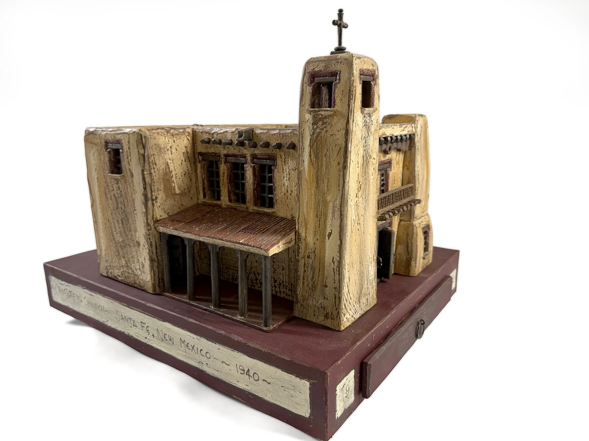 Cristo Rey Church sculpture by Roberto Cardinale, front three-quarter view showing the asymmetrical battered towers and the recessed balcony.