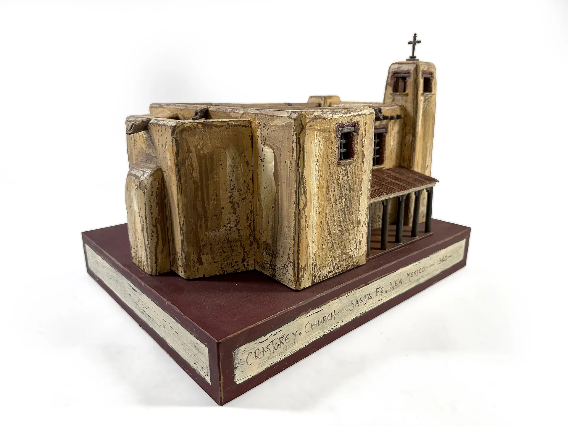 Cristo Rey Church sculpture from the rear, showing the long adobe nave and stepped roofline.