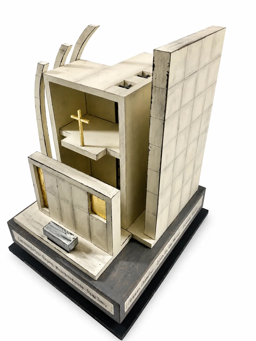 The Jubilee Church sculpture turned on its swivel base to show the interior, with the altar cross and gold leaf.
